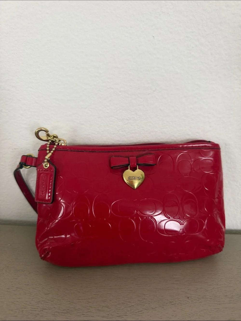 COACH Red Patent Signature Wristlet with Gold Heart Charm